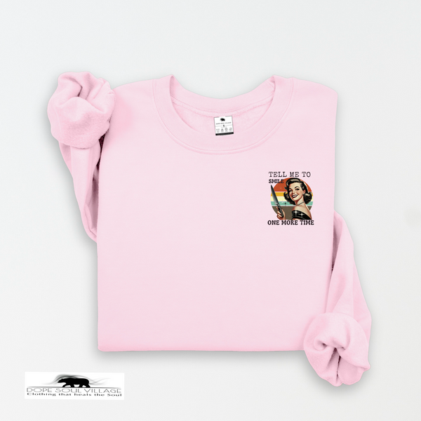 Pink sweatshirt with graphic design and text on a white background