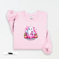 Pink sweatshirt with a cartoon ghost holding a pink ribbon on a white background