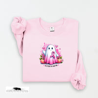 Pink sweatshirt with a cartoon ghost holding a pink ribbon on a white background