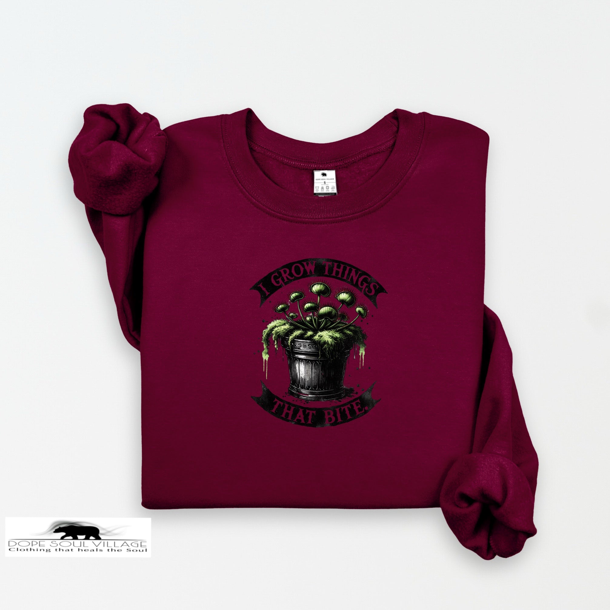 Maroon sweatshirt with graphic design and text on a white background