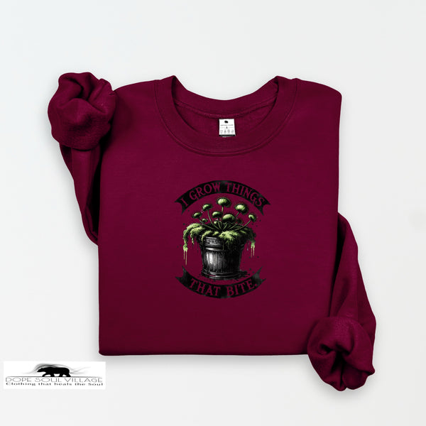 Maroon sweatshirt with graphic design and text on a white background