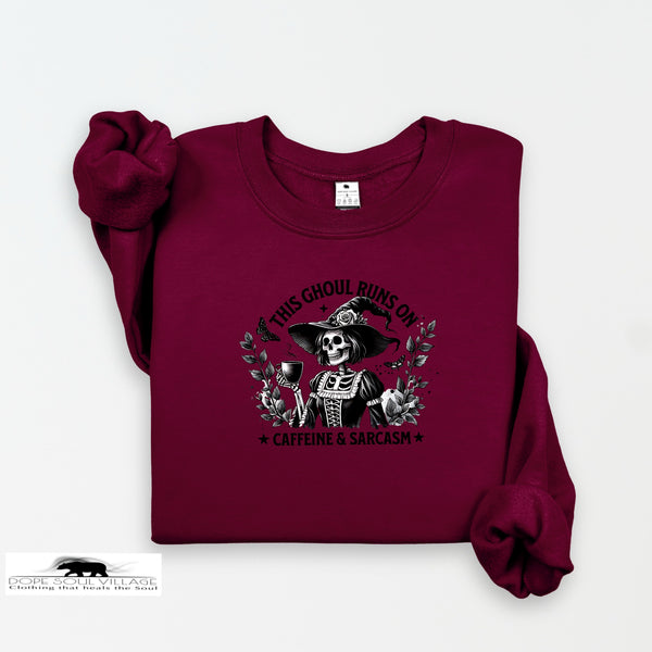 Maroon sweatshirt with a graphic design of a skeleton and text on a white background