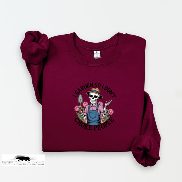 Maroon sweatshirt with a graphic design of a skeleton gardener and text on a white background