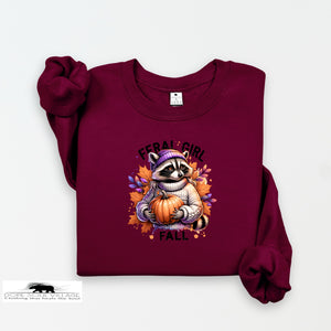 Maroon sweatshirt with a raccoon holding a pumpkin and 'Feral Girl Fall' text on a white background