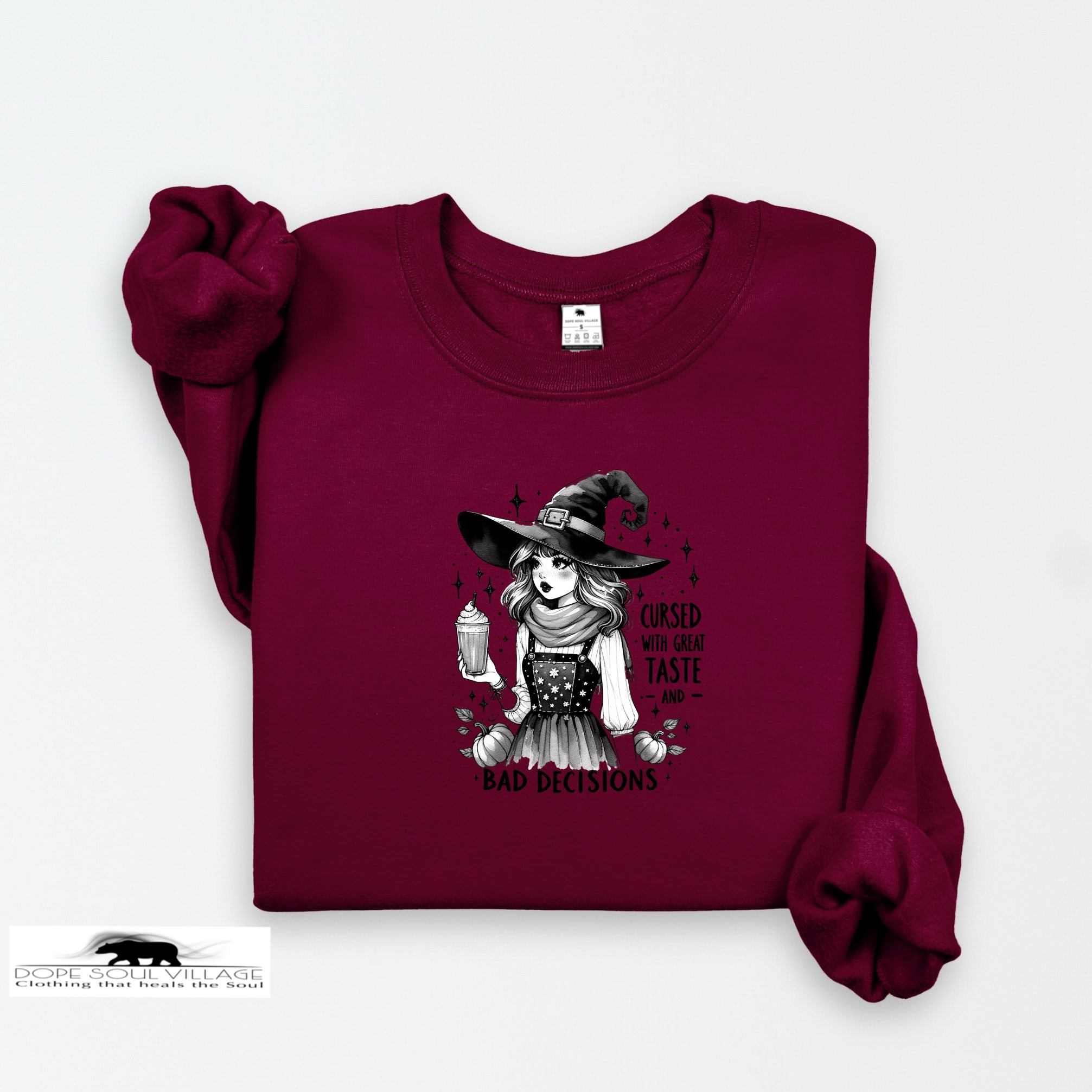 Maroon sweatshirt with a witch graphic and text on a white background