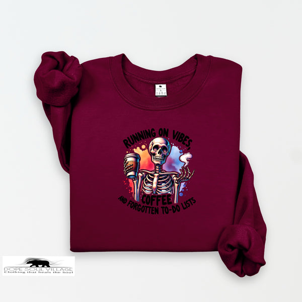 Maroon sweatshirt with skeleton and coffee graphic on a white background