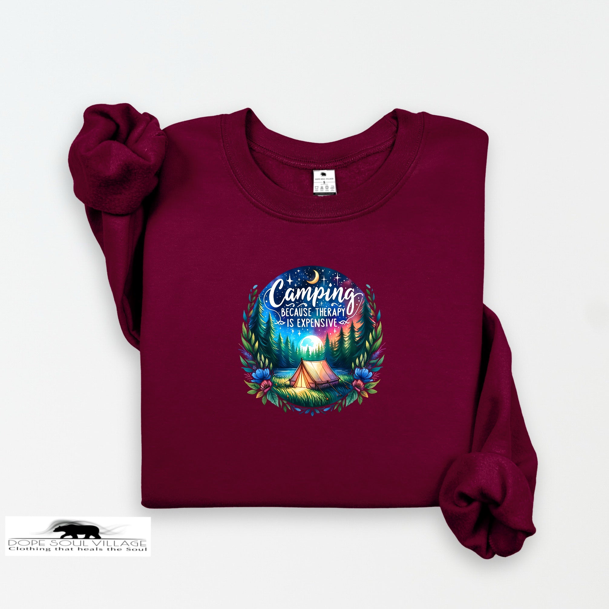 Maroon sweatshirt with a colorful camping graphic and text on a white background