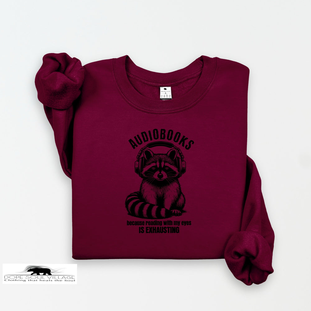 Maroon sweatshirt with raccoon graphic and text on a white background