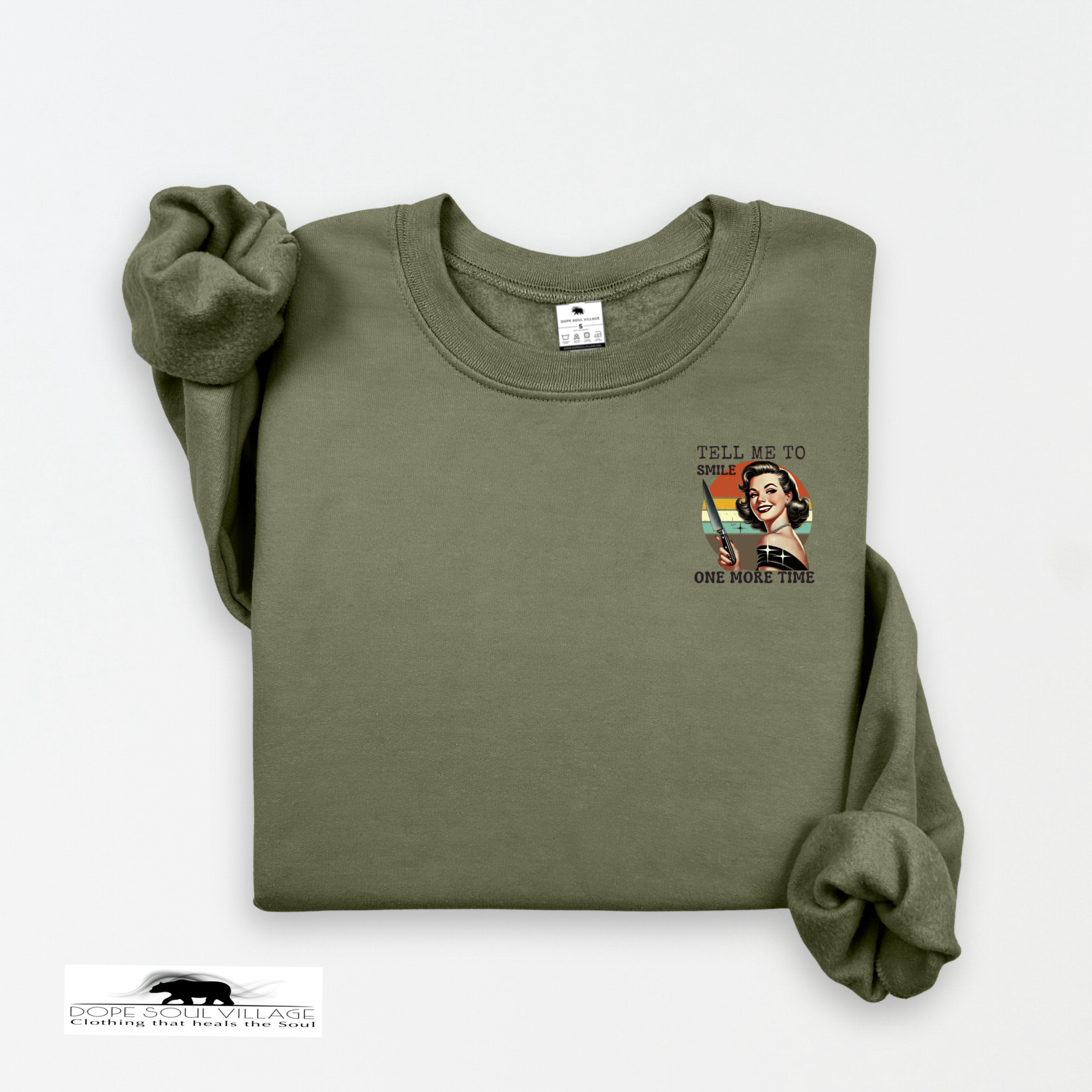 Folded green sweatshirt with graphic design on a white background