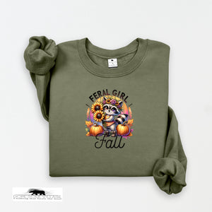Green sweatshirt with a raccoon and pumpkin design on a white background