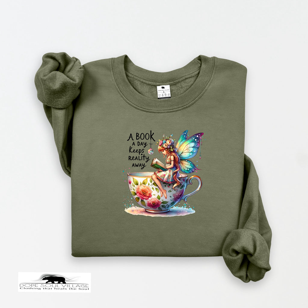 Green sweatshirt with a fairy and book design on a white background