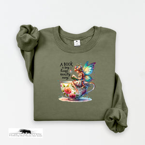 Green sweatshirt with a fairy and book design on a white background