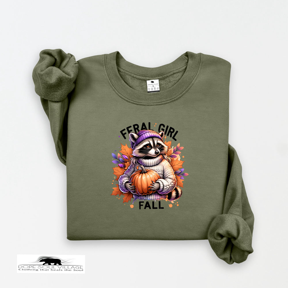 Green sweatshirt with a raccoon holding a pumpkin and 'Feral Girl Fall' text on a white background