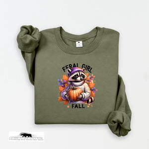 Green sweatshirt with a raccoon holding a pumpkin and 'Feral Girl Fall' text on a white background