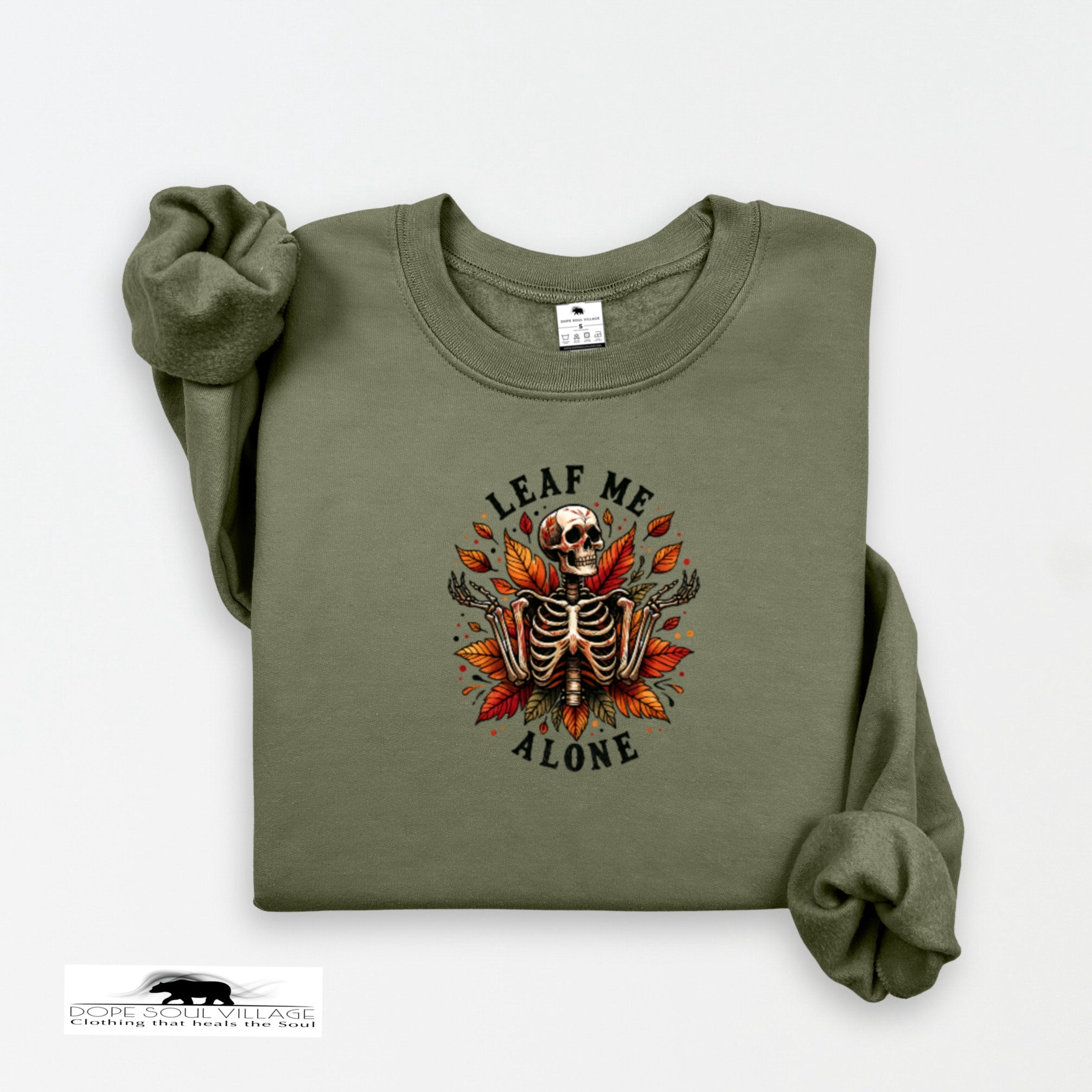 Green sweatshirt with skeleton and leaf design on a white background