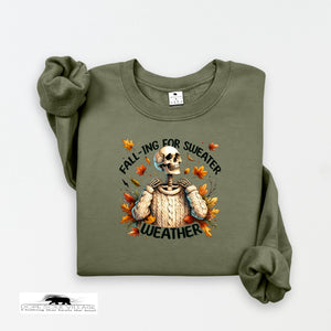 Green sweatshirt with skeleton design and 'Falling for Sweater Weather' text on a white background