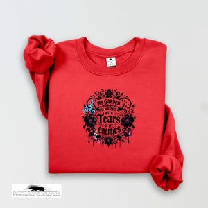 Red sweatshirt with black floral design and text on a light gray background