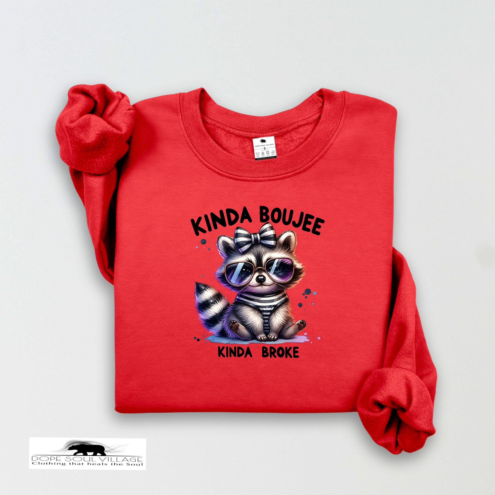 Red sweatshirt with a raccoon graphic and text on a light gray background