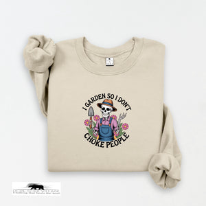 Beige sweatshirt with a graphic design featuring a skeleton gardener and text on a white background.