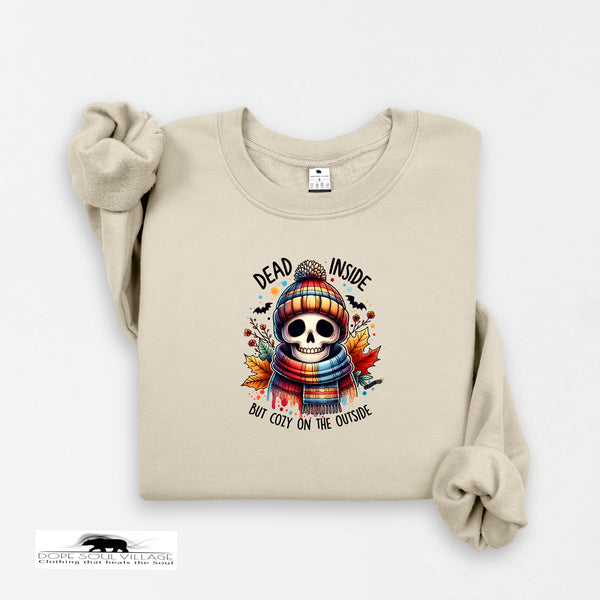 Beige sweatshirt with a skull design and text on a white background