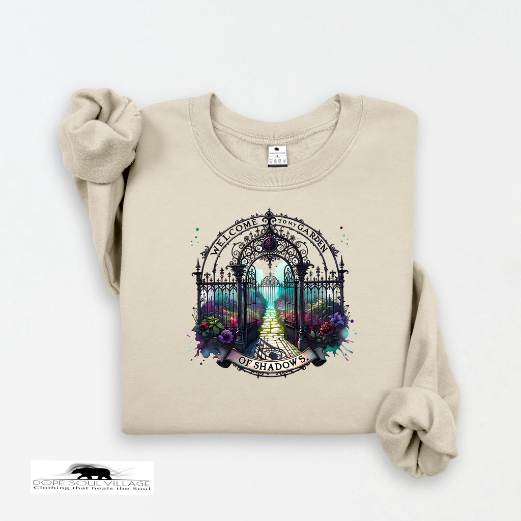 Beige sweatshirt with a decorative gate and floral design on a white background