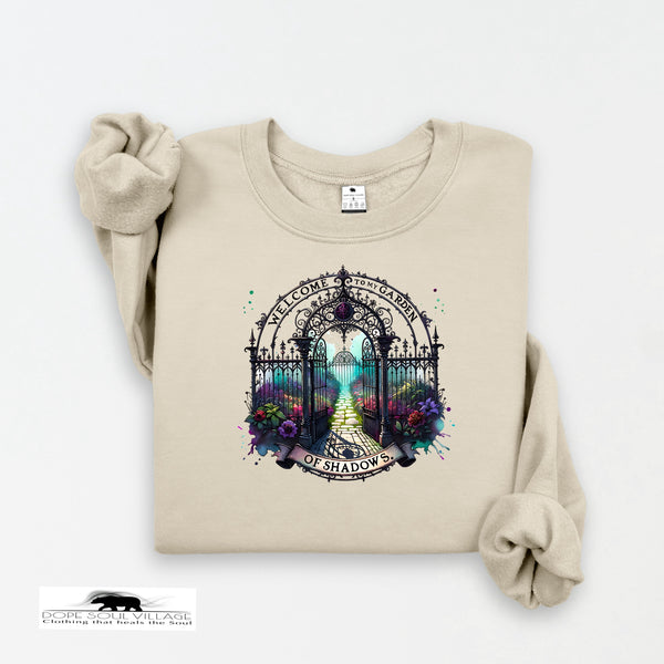 Beige sweatshirt with a decorative gate and floral design on a white background