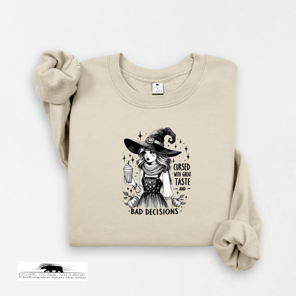 Beige sweatshirt with a witch graphic and text on a white background