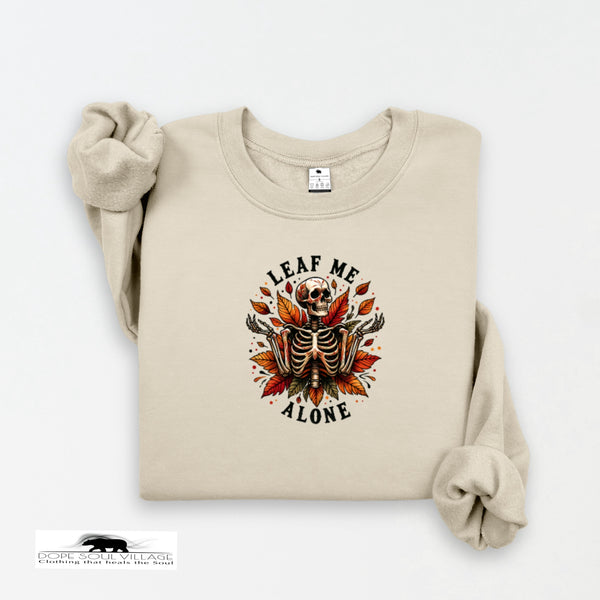 Beige sweatshirt with a skeleton and leaf design on a white background