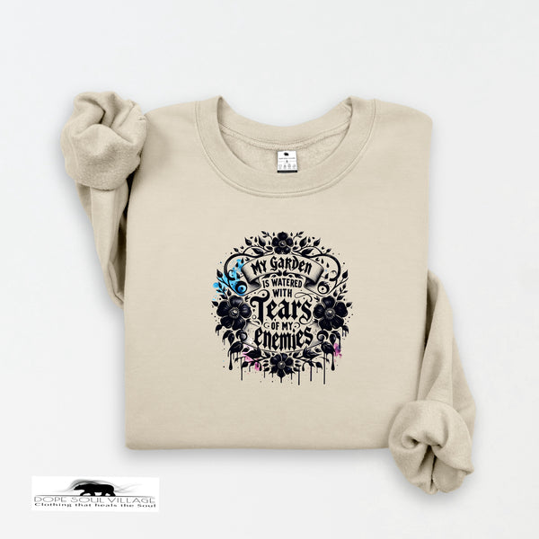Beige sweatshirt with black floral design and text on a white background