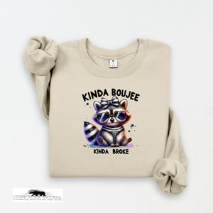 Beige sweatshirt with a raccoon graphic and text on a white background