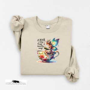 Beige sweatshirt with a colorful fairy design and text on a white background