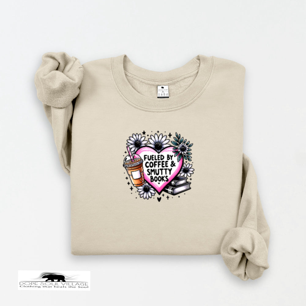 Beige sweatshirt with a graphic design featuring a heart, coffee cup, and books on a white background.