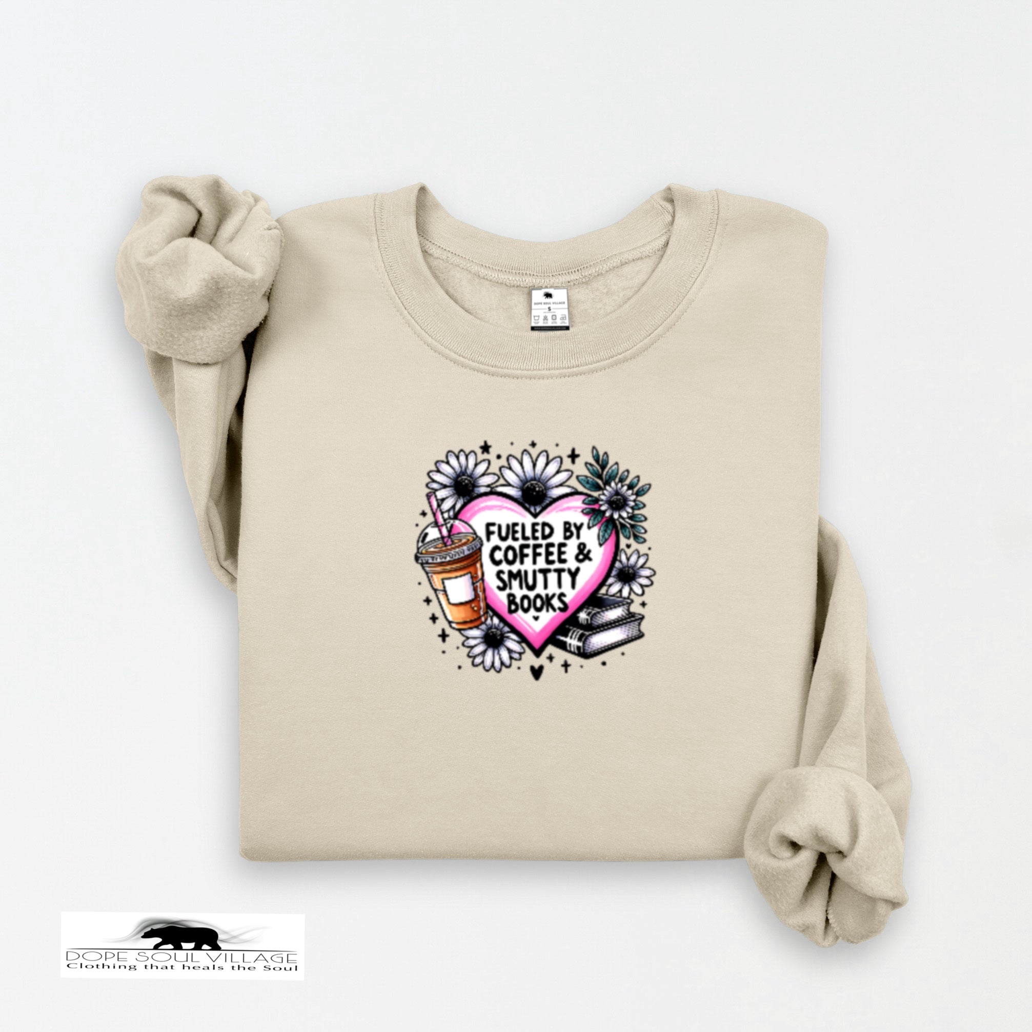 Beige sweatshirt with a graphic design featuring a heart, coffee cup, and books on a white background.