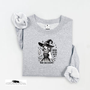 Gray sweatshirt with a witch graphic and text on a white background