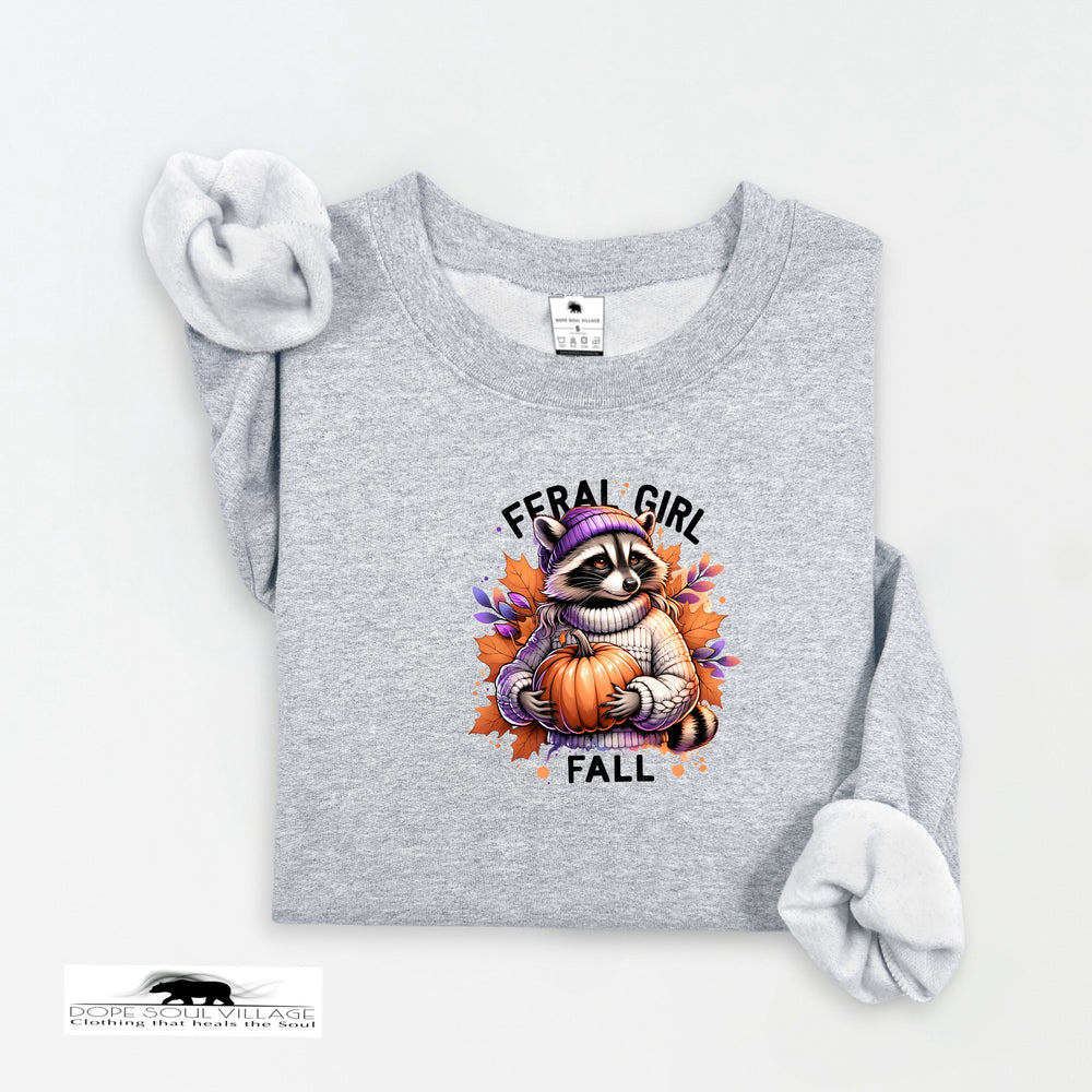 Gray sweatshirt with a raccoon holding a pumpkin and 'Feral Girl Fall' text on a white background.