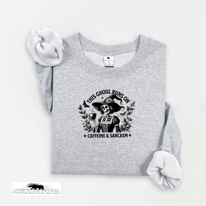 Gray sweatshirt with a graphic design and text on a white background