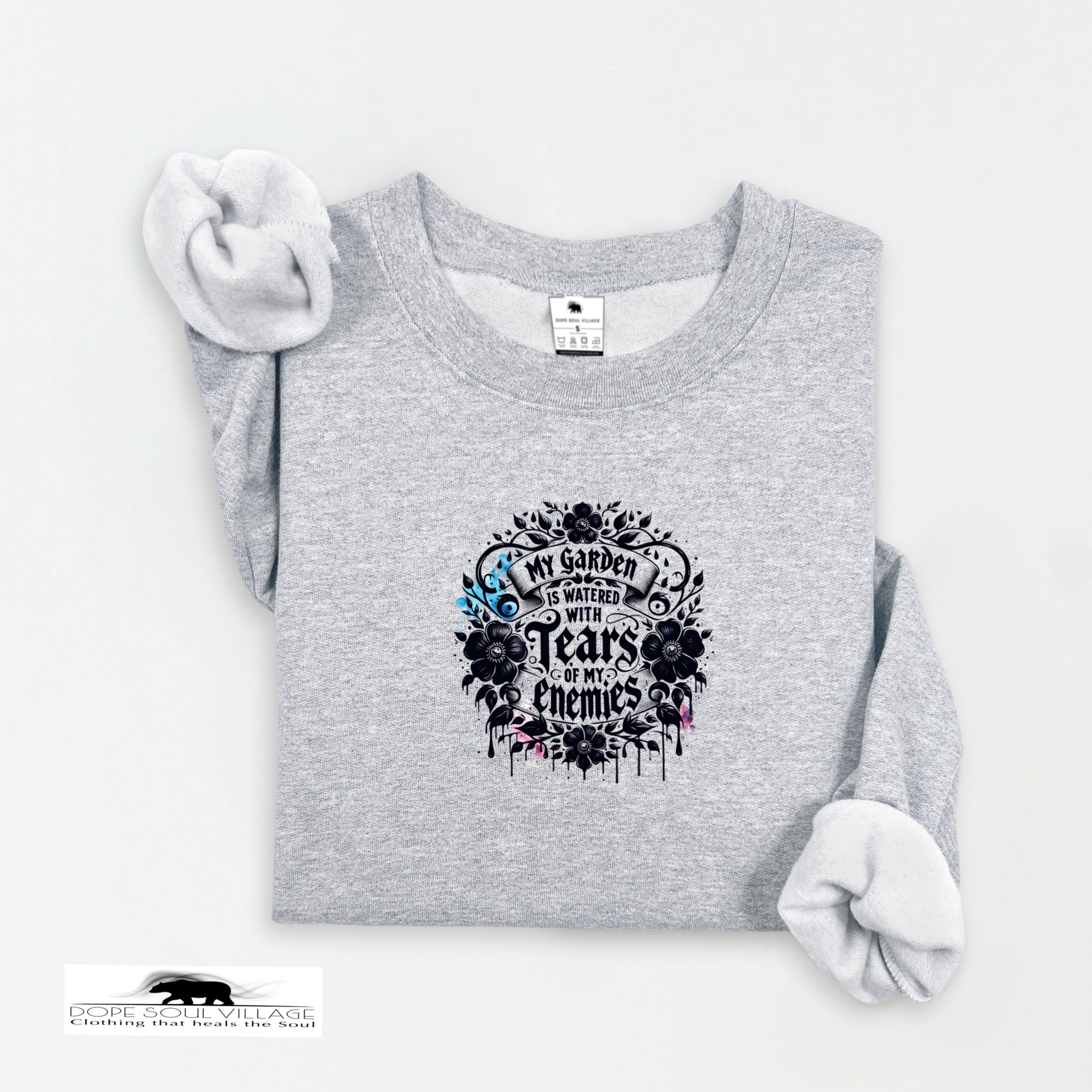 Gray sweatshirt with floral design and text on a white background