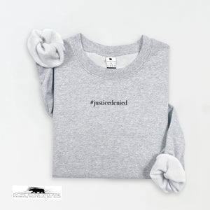 Gray sweatshirt with '#justicedenied' text on a white background rebecca goodwin