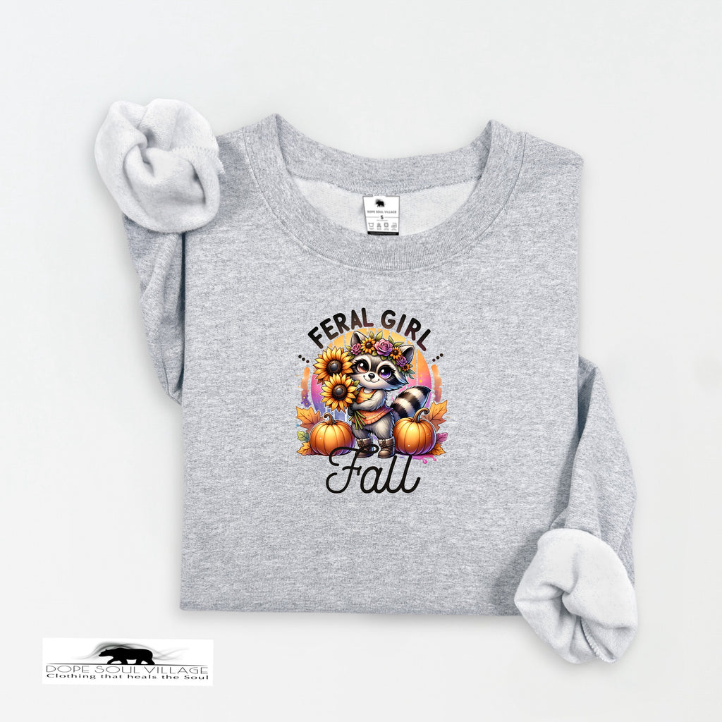 Gray sweatshirt with a graphic design featuring a raccoon, sunflowers, and pumpkins on a white background.