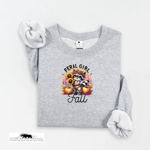 Gray sweatshirt with a graphic design featuring a raccoon, sunflowers, and pumpkins on a white background.