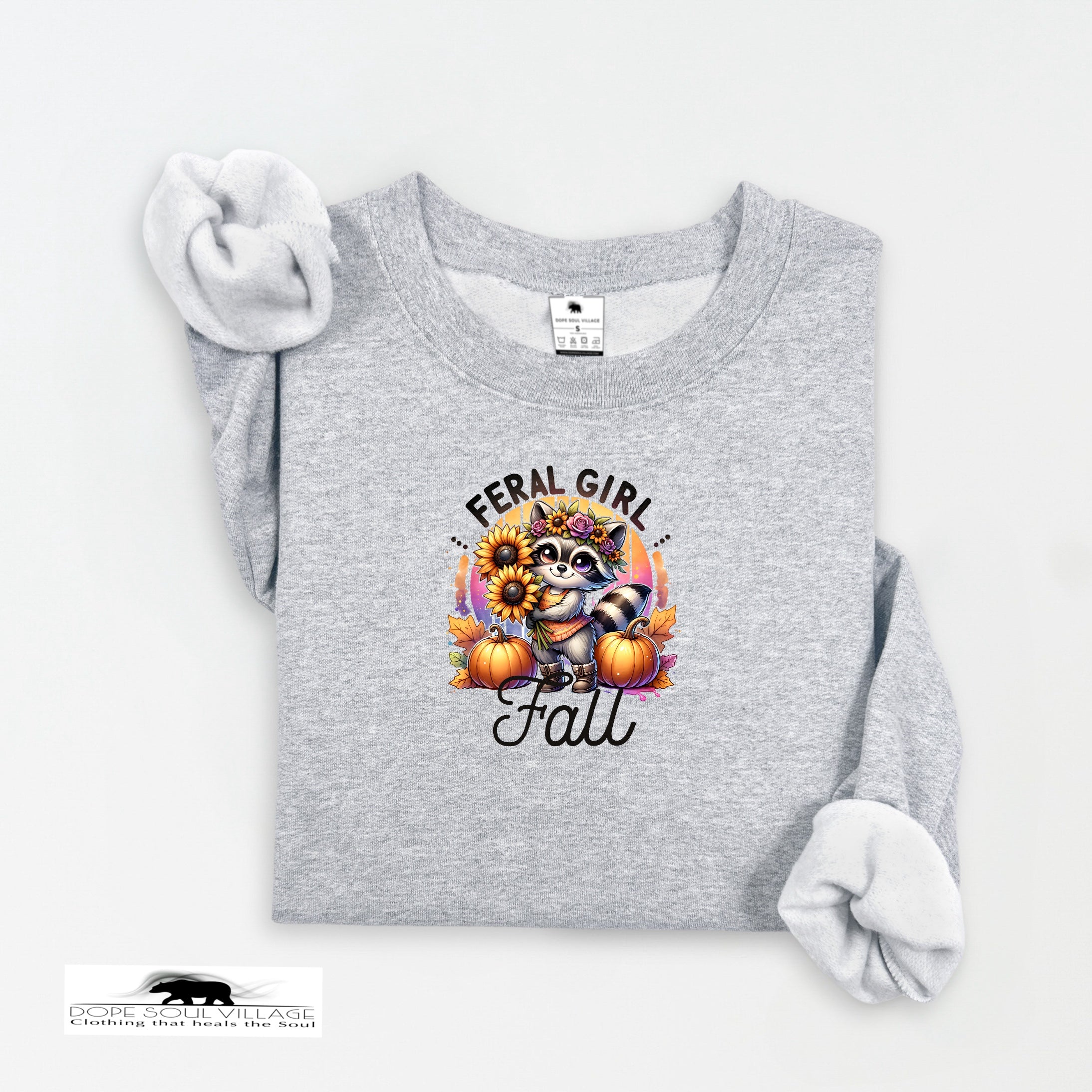 Gray sweatshirt with a graphic design featuring a raccoon, sunflowers, and pumpkins on a white background.