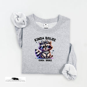 Gray sweatshirt with a raccoon graphic and text on a white background