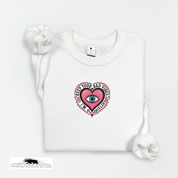 White t-shirt with a pink heart graphic and text on a white background