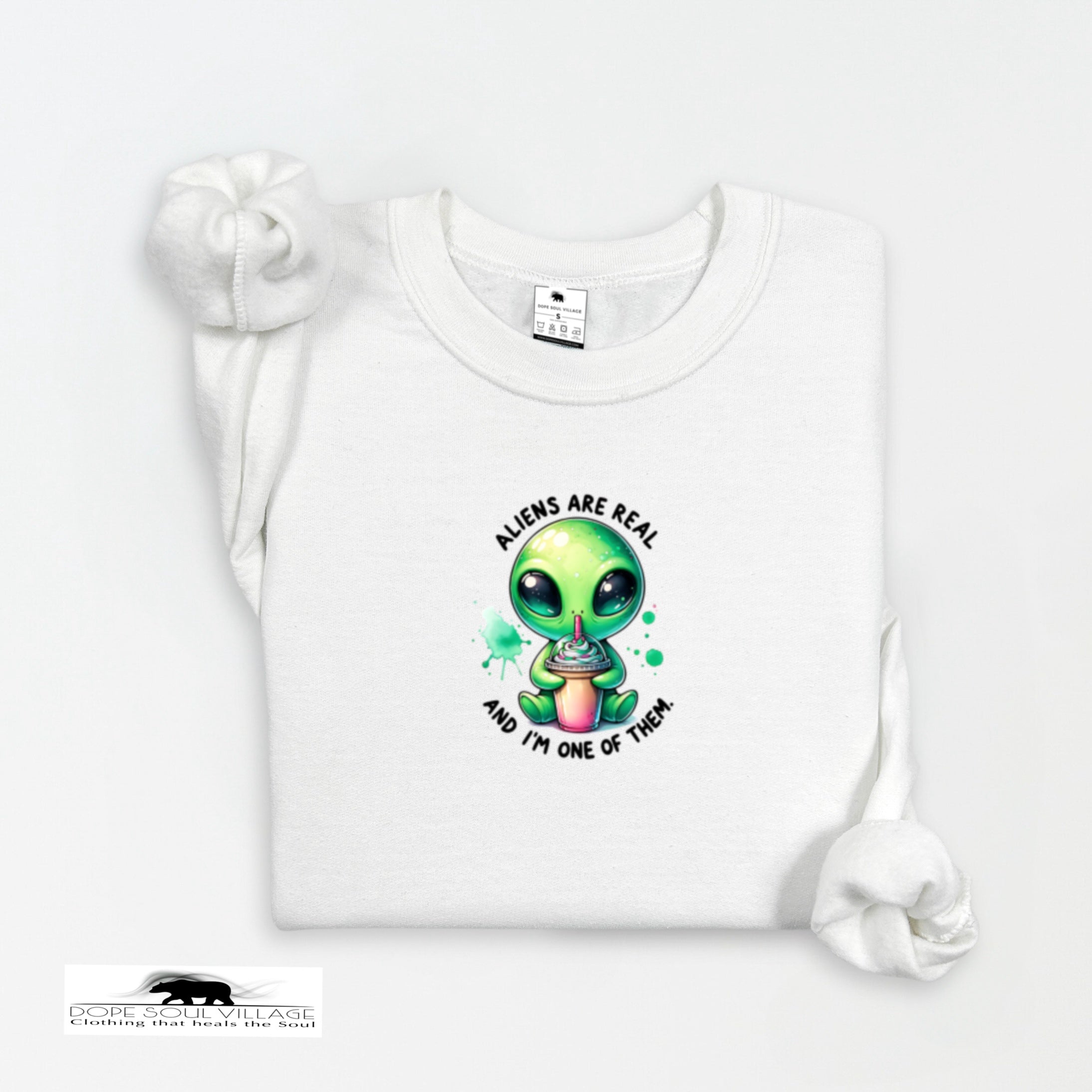 White t-shirt with a green alien graphic and text on a white background