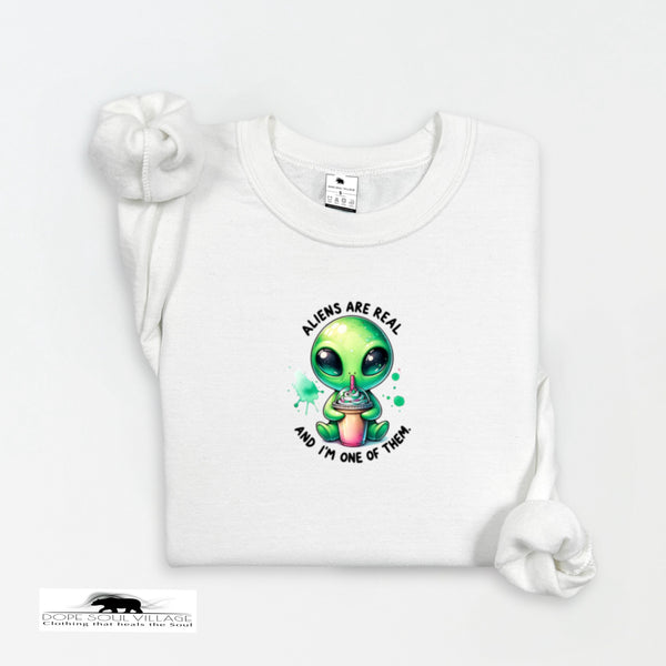 White t-shirt with a green alien graphic and text on a white background