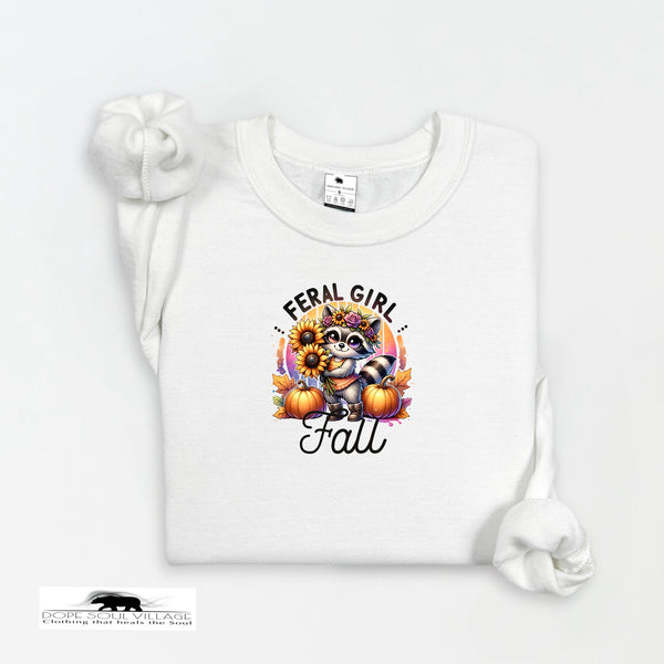 White t-shirt with a graphic design featuring a raccoon, pumpkins, and text on a white background.