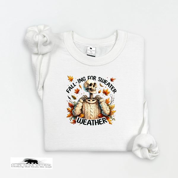 White sweatshirt with a skeleton wearing a sweater and autumn leaves design on a white background.