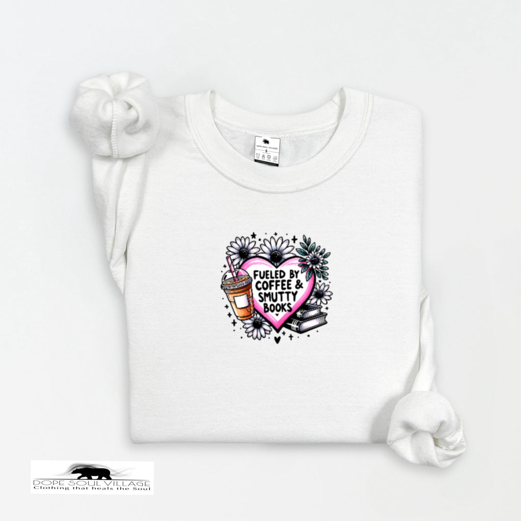 White t-shirt with a graphic design featuring a heart, coffee cup, and books on a white background.