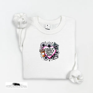 White t-shirt with a graphic design featuring a heart, coffee cup, and books on a white background.