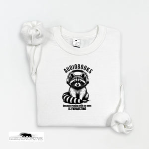 White t-shirt with raccoon graphic and 'audiobooks' text on a white background